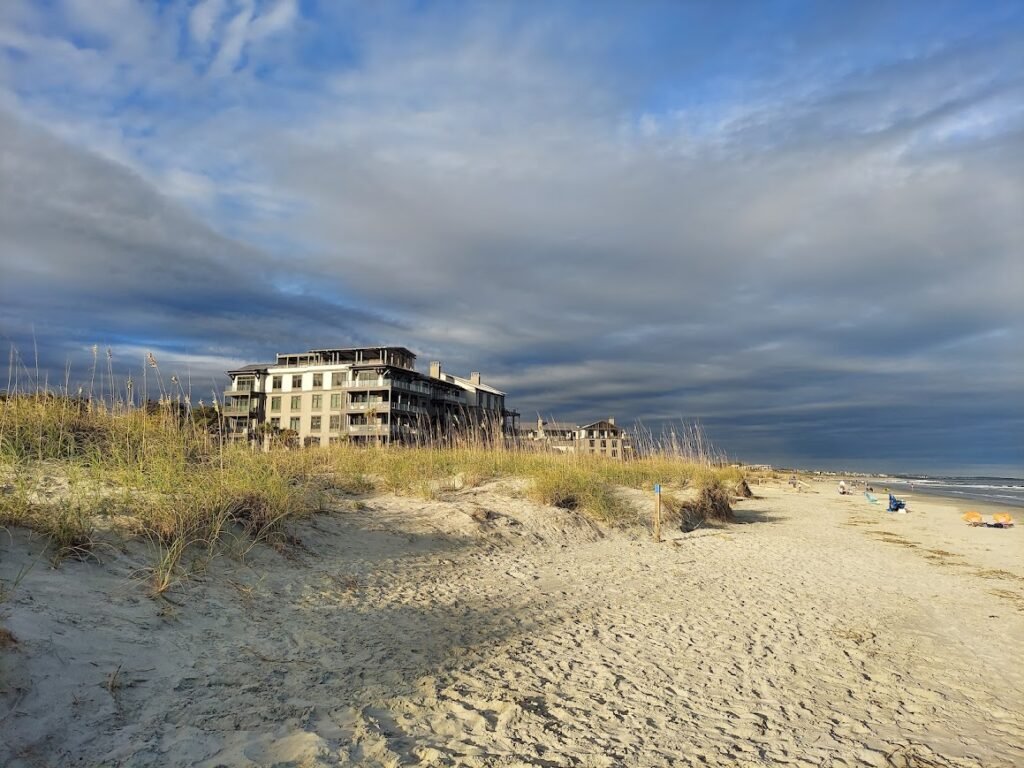 Wide sandy beach and dunes beside oceanfront buildings near Beachwalker Park on Kiawah Island, South Carolina.